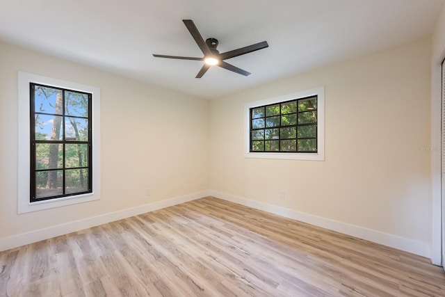 unfurnished room featuring ceiling fan, baseboards, and light wood-style floors