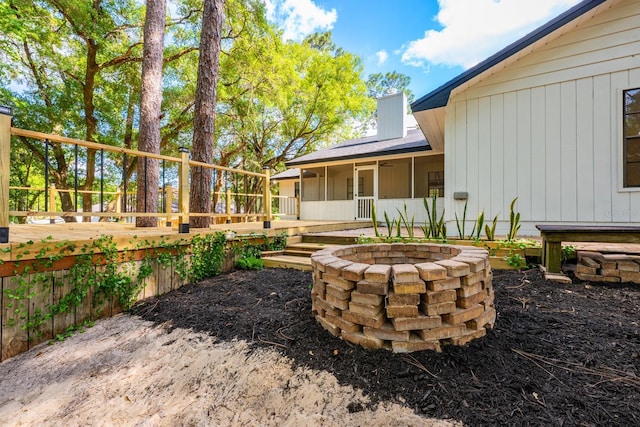 view of yard with a fire pit and a deck