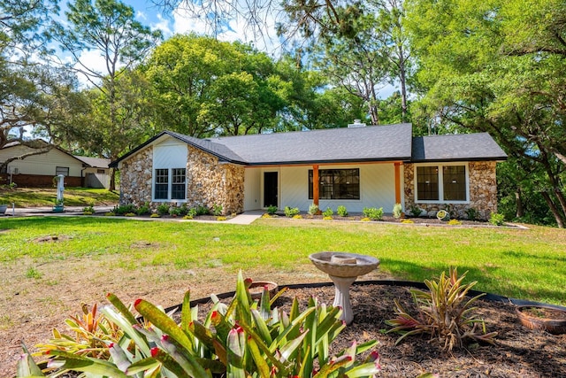 single story home with stone siding and a front lawn