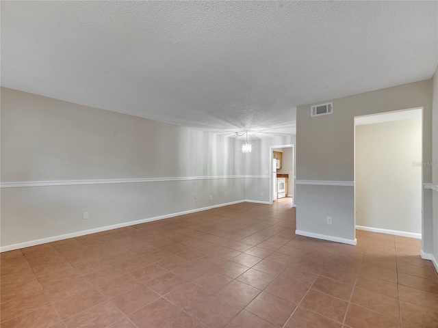 200 Saint Andrews Blvd Unit 2306, Winter Park, FL 32792 - tiled spare room with a textured ceiling and a chandelier
