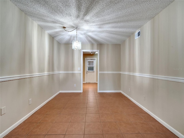 200 Saint Andrews Blvd Unit 2306, Winter Park, FL 32792 - tiled empty room with a chandelier and a textured ceiling