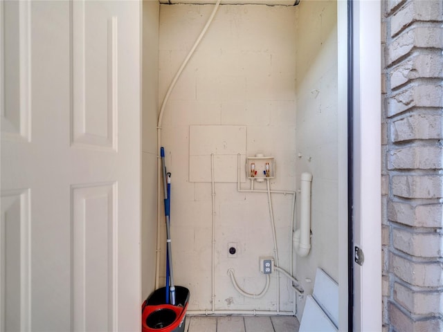 200 Saint Andrews Blvd Unit 2306, Winter Park, FL 32792 - washroom featuring washer hookup, tile patterned flooring, and concrete block wall