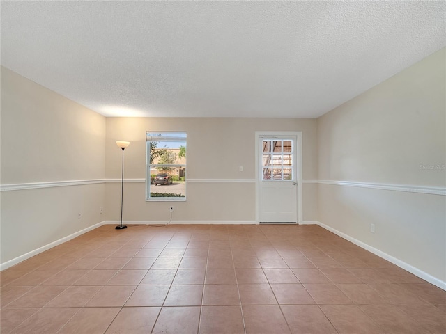 200 Saint Andrews Blvd Unit 2306, Winter Park, FL 32792 - unfurnished room featuring plenty of natural light, a textured ceiling, and light tile patterned floors