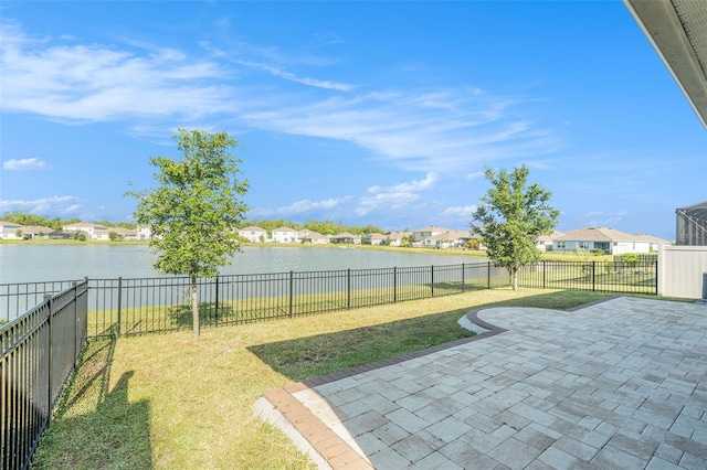 view of yard featuring a residential view, a patio, a water view, and a fenced backyard