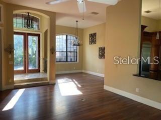 708 Palenci Ct, Winter Springs, FL 32708 - foyer entrance featuring baseboards, wood finished floors, a chandelier, and a ceiling fan