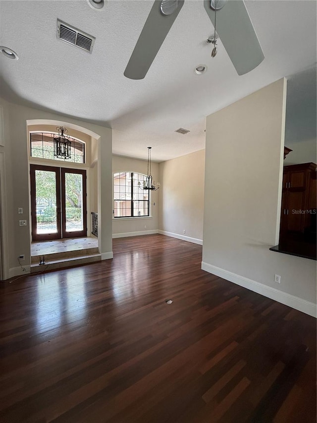 708 Palenci Ct, Winter Springs, FL 32708 - unfurnished living room featuring a chandelier, dark wood-style floors, a ceiling fan, baseboards, and a textured ceiling