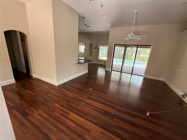 708 Palenci Ct, Winter Springs, FL 32708 - unfurnished living room featuring arched walkways, a ceiling fan, dark wood finished floors, baseboards, and recessed lighting