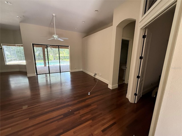708 Palenci Ct, Winter Springs, FL 32708 - empty room featuring arched walkways, dark wood finished floors, a ceiling fan, baseboards, and recessed lighting