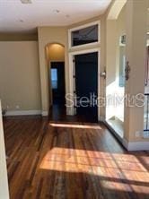 708 Palenci Ct, Winter Springs, FL 32708 - corridor with arched walkways, baseboards, and wood finished floors