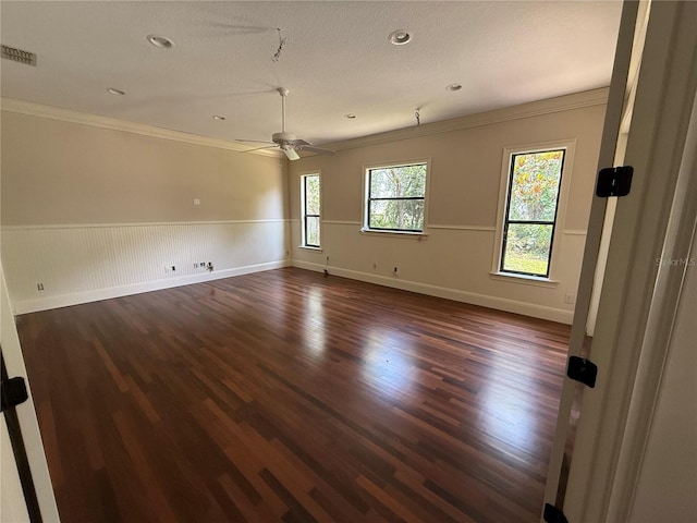 708 Palenci Ct, Winter Springs, FL 32708 - spare room with crown molding, dark wood-style flooring, a wainscoted wall, ceiling fan, and baseboards