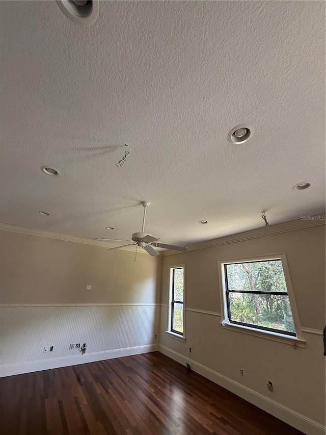 708 Palenci Ct, Winter Springs, FL 32708 - unfurnished room with a textured ceiling, dark wood-style floors, a wainscoted wall, ornamental molding, and ceiling fan