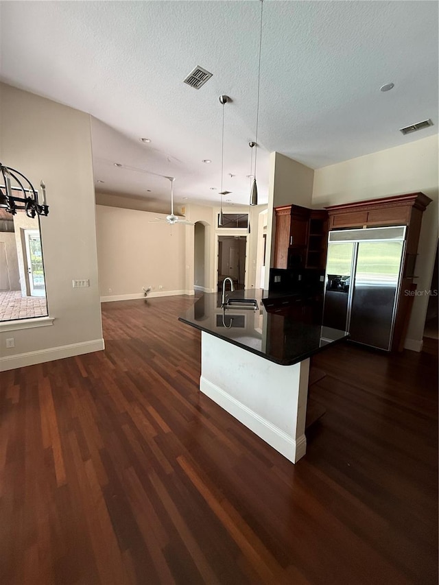 708 Palenci Ct, Winter Springs, FL 32708 - kitchen featuring built in refrigerator, dark countertops, open floor plan, a ceiling fan, and dark wood finished floors