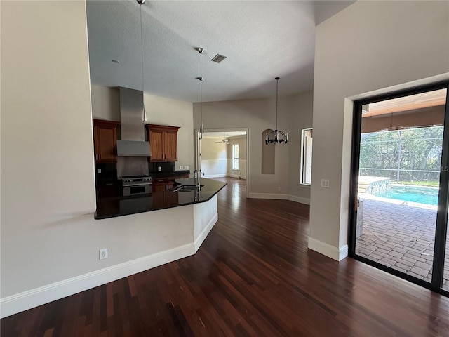 708 Palenci Ct, Winter Springs, FL 32708 - kitchen featuring wall chimney exhaust hood, high end stove, dark countertops, dark wood finished floors, and baseboards