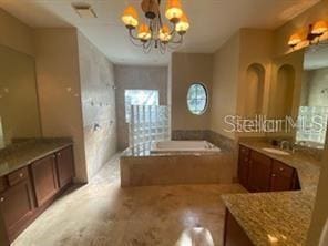 708 Palenci Ct, Winter Springs, FL 32708 - full bath featuring a chandelier, a garden tub, and vanity