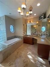 708 Palenci Ct, Winter Springs, FL 32708 - full bath with a chandelier, a bath, vanity, and recessed lighting