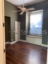 708 Palenci Ct, Winter Springs, FL 32708 - unfurnished bedroom with dark wood-style flooring, baseboards, and ceiling fan