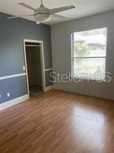708 Palenci Ct, Winter Springs, FL 32708 - unfurnished bedroom featuring wood finished floors, baseboards, and a ceiling fan