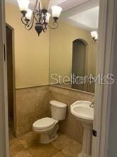 708 Palenci Ct, Winter Springs, FL 32708 - bathroom featuring a chandelier, toilet, and tile patterned floors