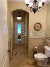 708 Palenci Ct, Winter Springs, FL 32708 - bathroom featuring a chandelier and toilet