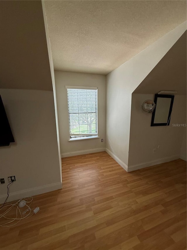 708 Palenci Ct, Winter Springs, FL 32708 - bonus room featuring a textured ceiling, light wood-style flooring, and baseboards