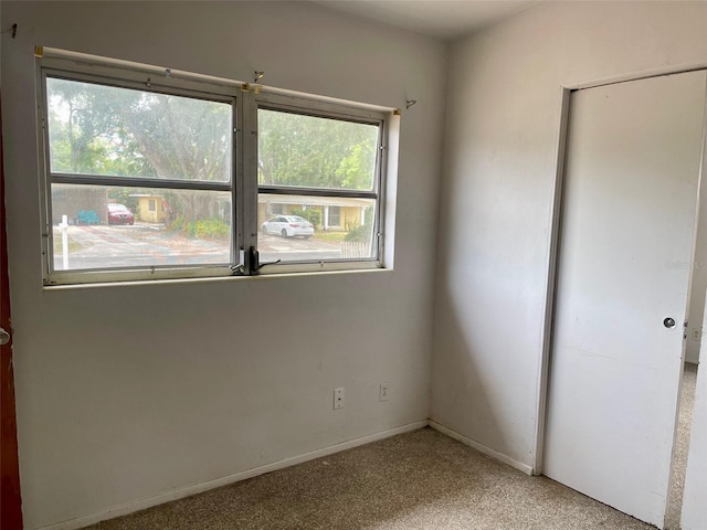 unfurnished bedroom featuring carpet flooring and baseboards