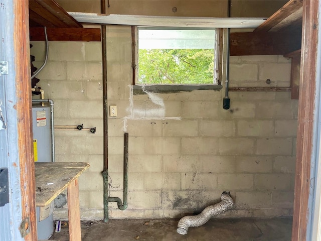basement with water heater and concrete block wall