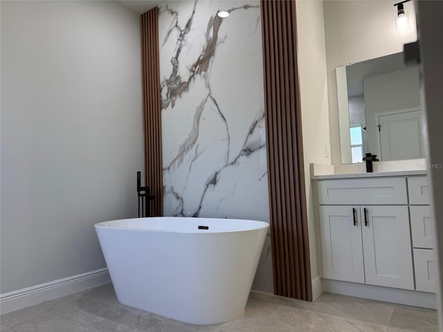 2406 SW 163rd Pl, Ocala, FL 34473 - full bathroom with marble finish floors, a freestanding bath, baseboards, and vanity