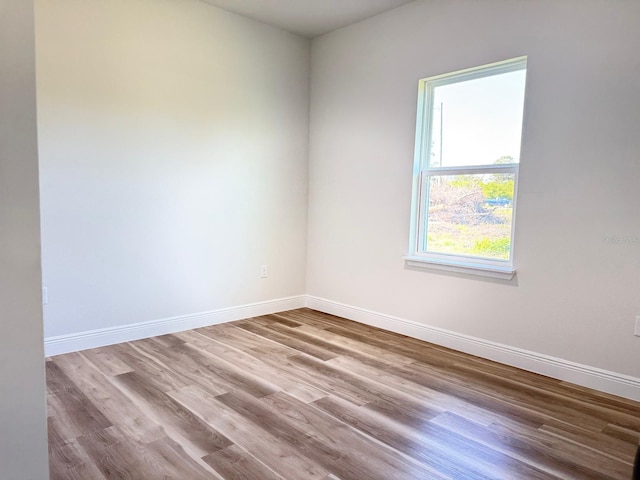 2406 SW 163rd Pl, Ocala, FL 34473 - empty room with wood finished floors and baseboards
