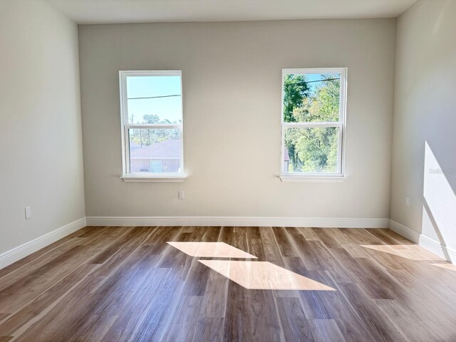 2406 SW 163rd Pl, Ocala, FL 34473 - empty room featuring wood finished floors and baseboards
