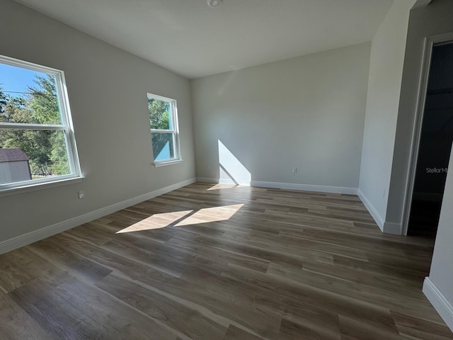 2406 SW 163rd Pl, Ocala, FL 34473 - unfurnished room with baseboards, wood finished floors, and lofted ceiling