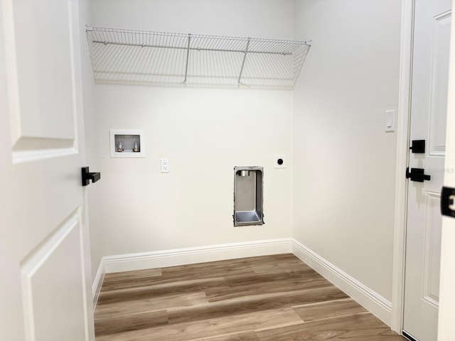 2406 SW 163rd Pl, Ocala, FL 34473 - laundry area with hookup for an electric dryer, hookup for a washing machine, baseboards, and wood finished floors