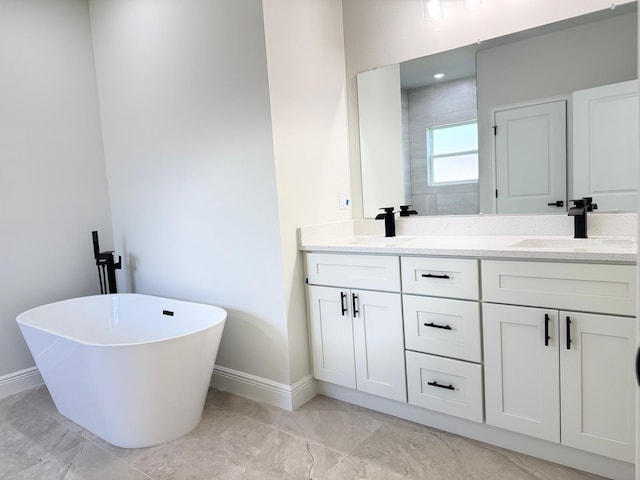 2406 SW 163rd Pl, Ocala, FL 34473 - bathroom with baseboards, double vanity, a soaking tub, and marble finish floors