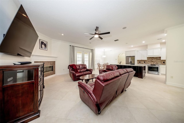 878 Cardinal Pointe Cv, Sanford, FL 32771 - living room featuring crown molding, light tile patterned floors, a fireplace, and a ceiling fan