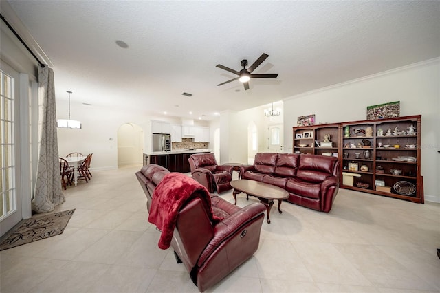 878 Cardinal Pointe Cv, Sanford, FL 32771 - living room with light tile patterned floors, arched walkways, baseboards, and ceiling fan with notable chandelier