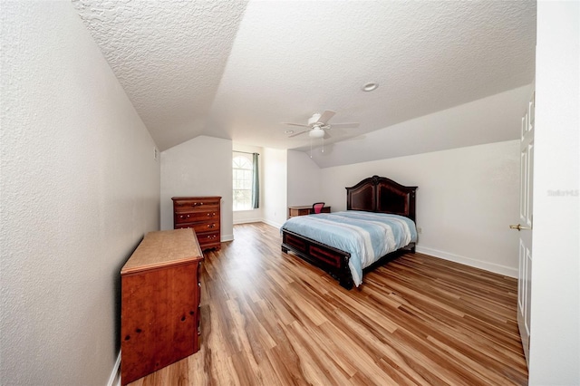 878 Cardinal Pointe Cv, Sanford, FL 32771 - bedroom featuring a textured ceiling, baseboards, vaulted ceiling, and light wood-type flooring