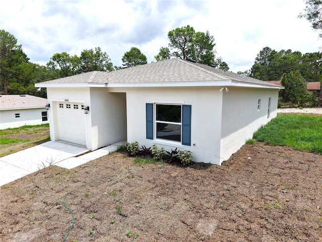 8990 Glenarm Way, Weeki Wachee, FL 34613 - ranch-style home with a garage, concrete driveway, stucco siding, and a shingled roof