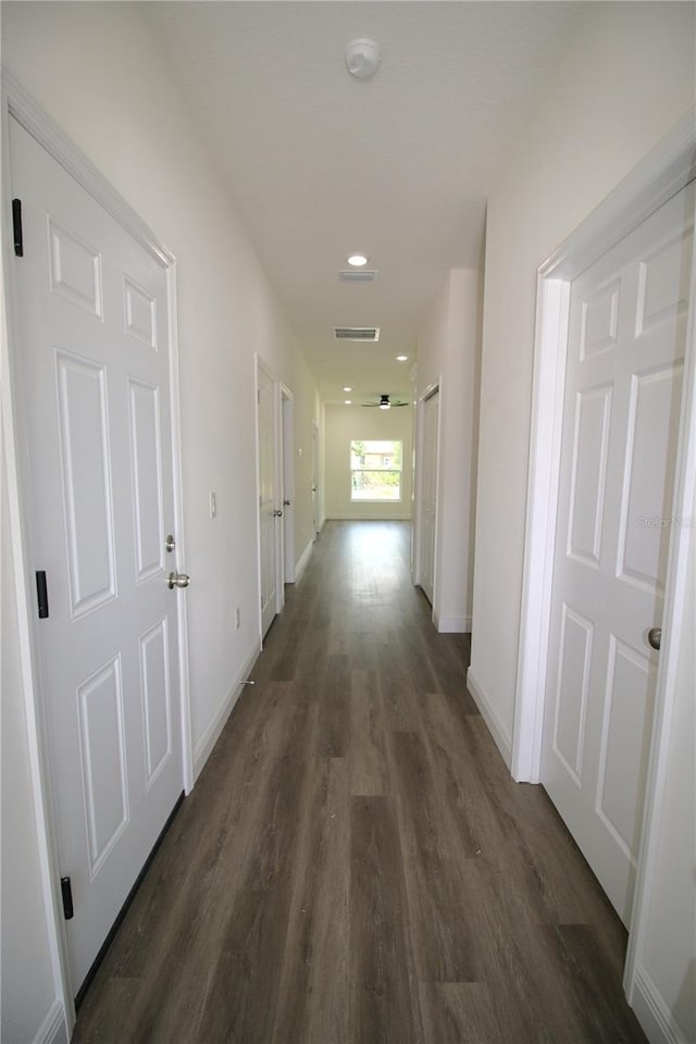 8990 Glenarm Way, Weeki Wachee, FL 34613 - hallway featuring dark wood finished floors and baseboards