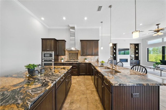 7624 Pointe Venezia Dr, Orlando, FL 32836 - kitchen with wall chimney exhaust hood, stainless steel appliances, decorative backsplash, dark brown cabinetry, and dark stone counters