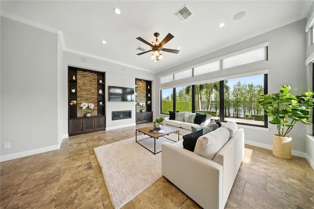 7624 Pointe Venezia Dr, Orlando, FL 32836 - living area with crown molding, a ceiling fan, a glass covered fireplace, built in shelves, and recessed lighting