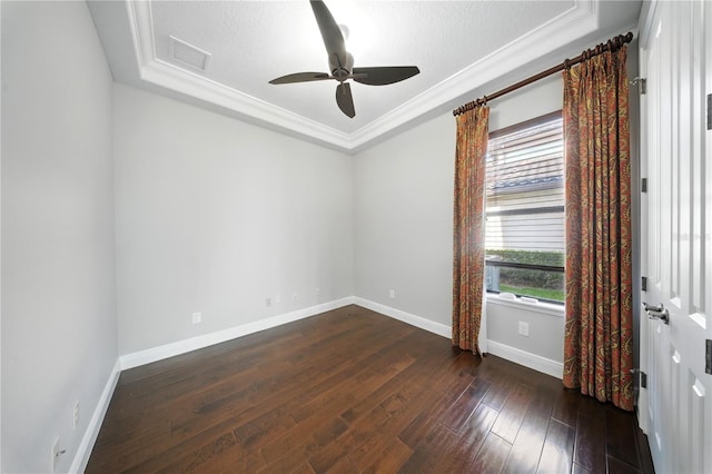 7624 Pointe Venezia Dr, Orlando, FL 32836 - empty room featuring a tray ceiling, a ceiling fan, dark wood finished floors, and crown molding