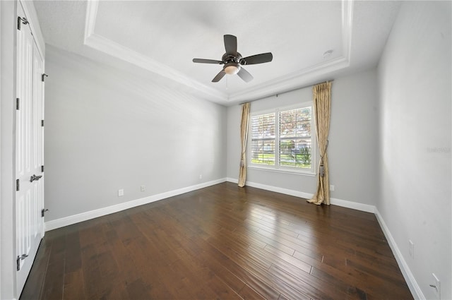 7624 Pointe Venezia Dr, Orlando, FL 32836 - unfurnished room with a tray ceiling, ceiling fan, and wood-type flooring