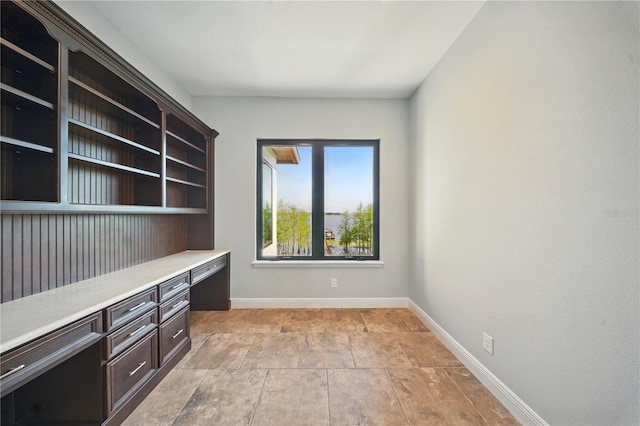 7624 Pointe Venezia Dr, Orlando, FL 32836 - unfurnished office featuring built in desk and light stone finish flooring