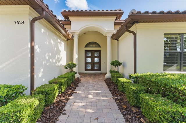 7624 Pointe Venezia Dr, Orlando, FL 32836 - property entrance with stucco siding and a tile roof