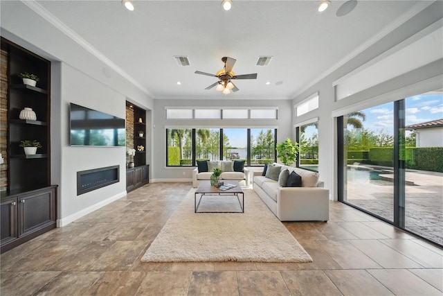 7624 Pointe Venezia Dr, Orlando, FL 32836 - living room with built in shelves, ornamental molding, a glass covered fireplace, a ceiling fan, and recessed lighting