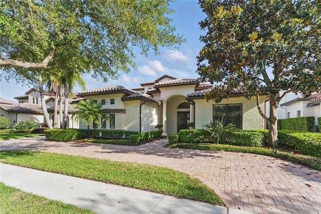 7624 Pointe Venezia Dr, Orlando, FL 32836 - mediterranean / spanish home featuring stucco siding and a tiled roof