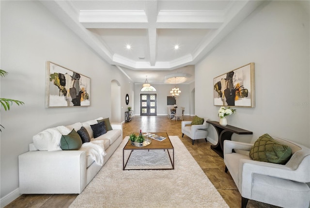 7624 Pointe Venezia Dr, Orlando, FL 32836 - living area with arched walkways, coffered ceiling, beamed ceiling, a chandelier, and ornamental molding
