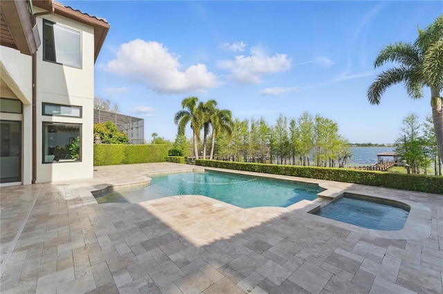 7624 Pointe Venezia Dr, Orlando, FL 32836 - view of pool featuring a patio area, a water view, and a pool with connected hot tub