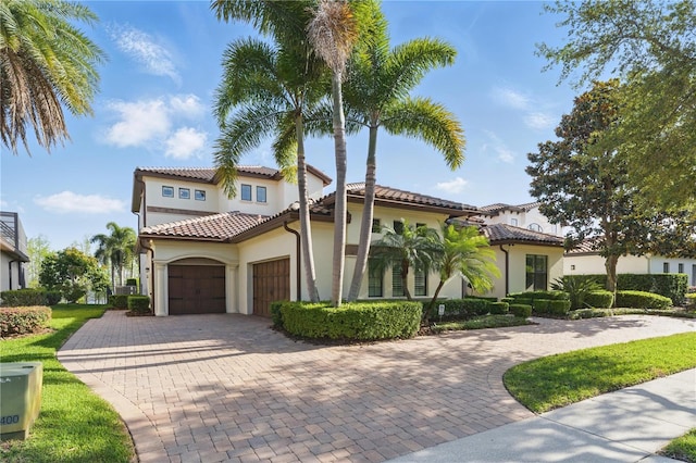 7624 Pointe Venezia Dr, Orlando, FL 32836 - mediterranean / spanish home with a garage, decorative driveway, stucco siding, and a tile roof