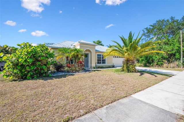 mediterranean / spanish-style house with stucco siding, an attached garage, a front lawn, and concrete driveway
