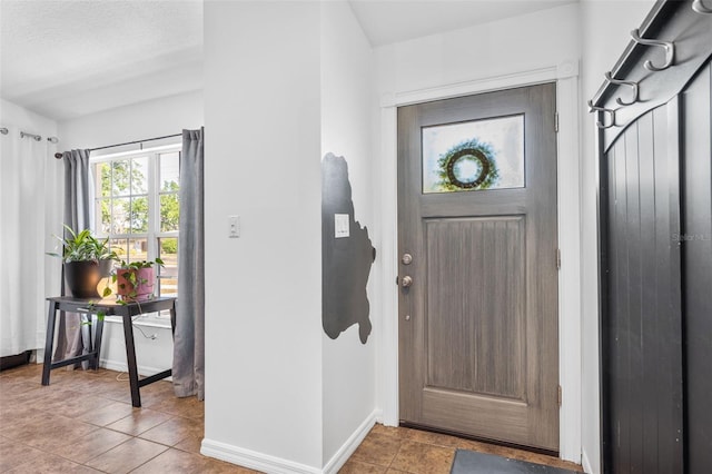 entryway featuring tile patterned flooring and baseboards